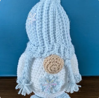 Elsie, a pale blue crocheted gonk with a ribbed hat and two plaits